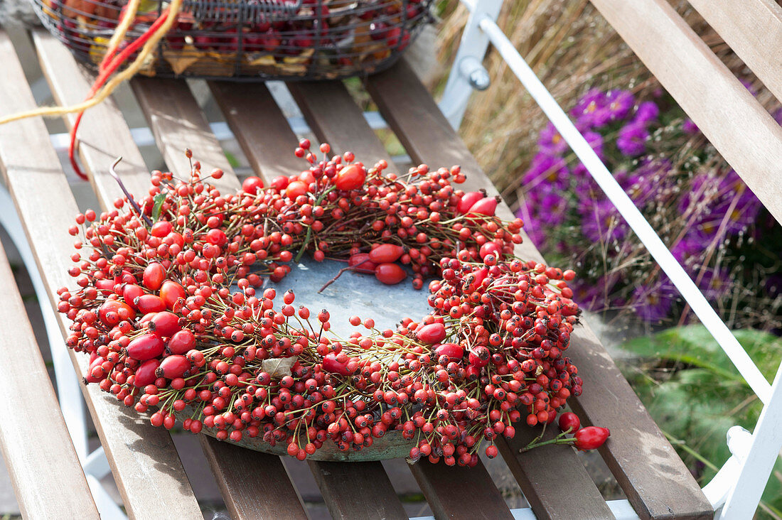 Wreath made of roses (rosehip) with bowl placed on bench