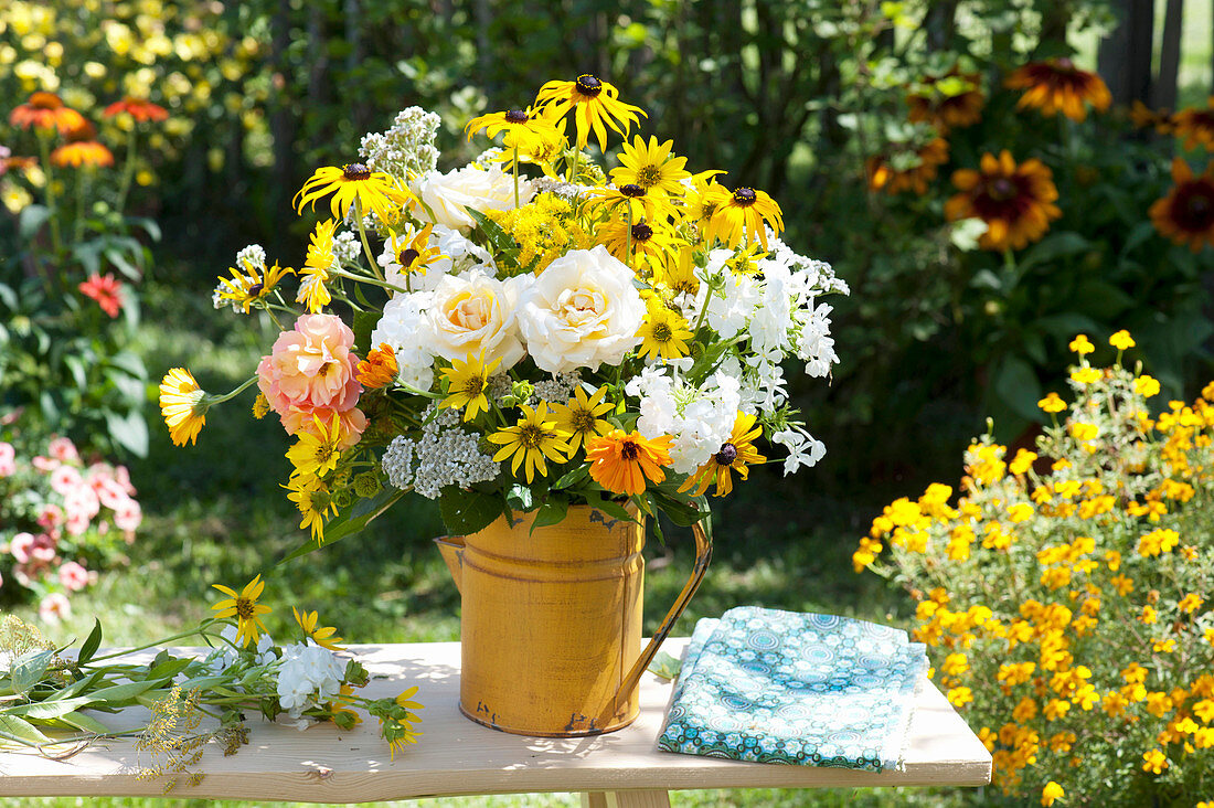 Rural bouquet in yellow tin can