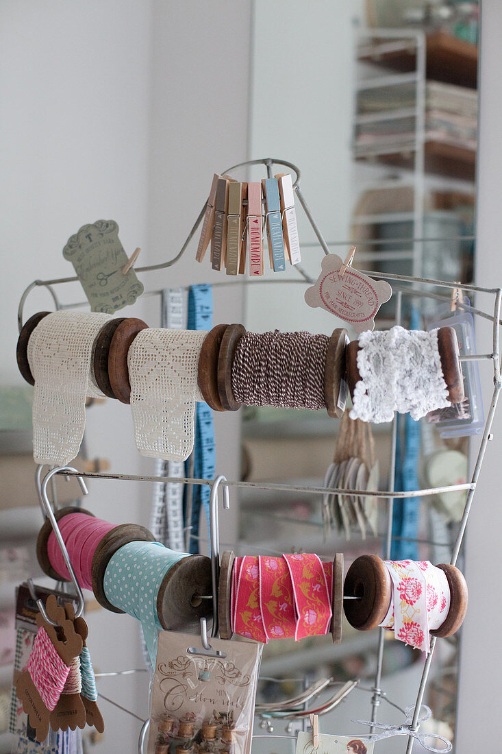 Reels of vintage-style trims and ribbons hung from tailors' dummy