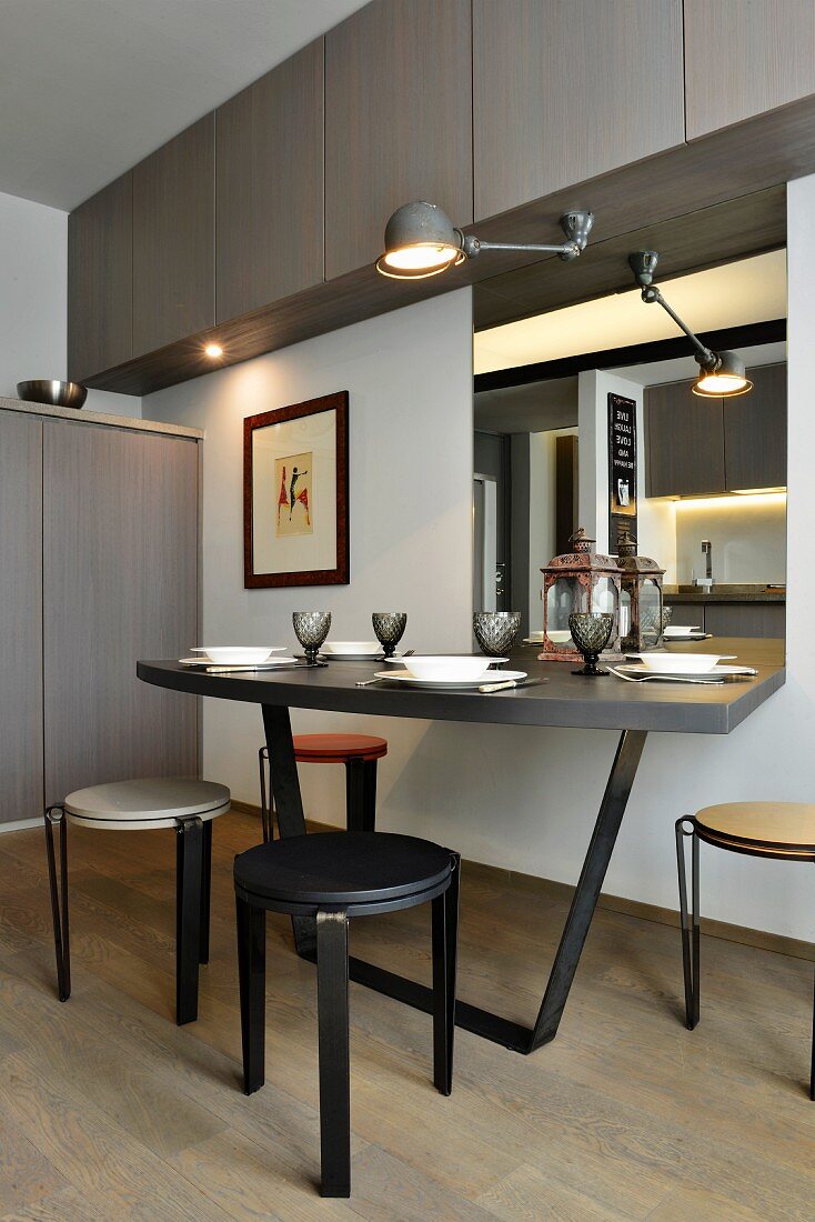 Minimalist dining area below wall-mounted cupboards