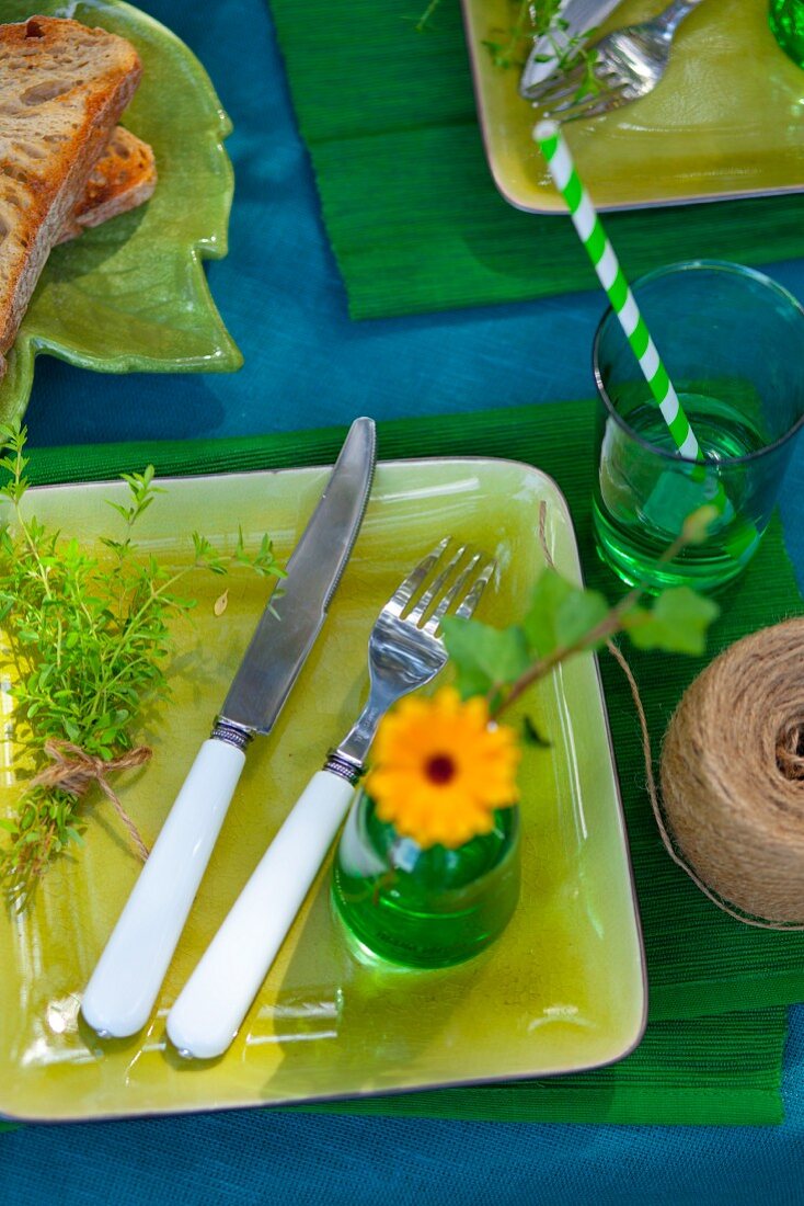 Table festively set in shades of blue and green outdoors