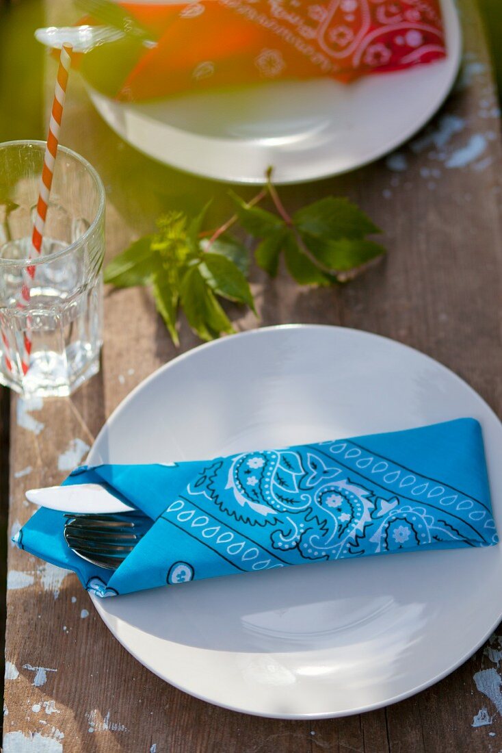 Bandanas used as napkins on rustic wooden table in garden