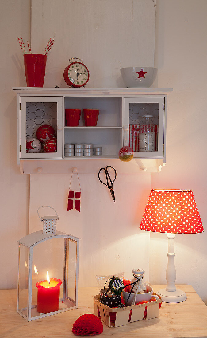 Red and white ornaments on wall-mounted cabinet and desk
