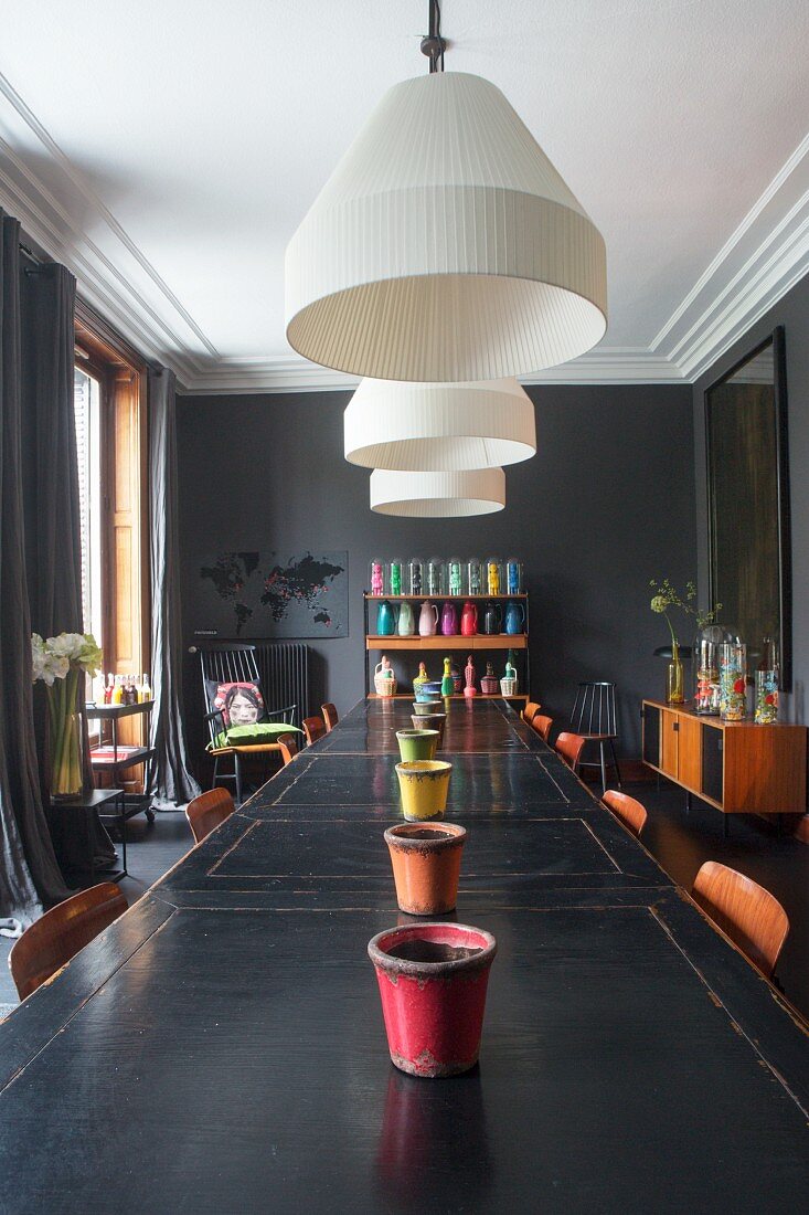 Vintage tables and dark walls in dining room