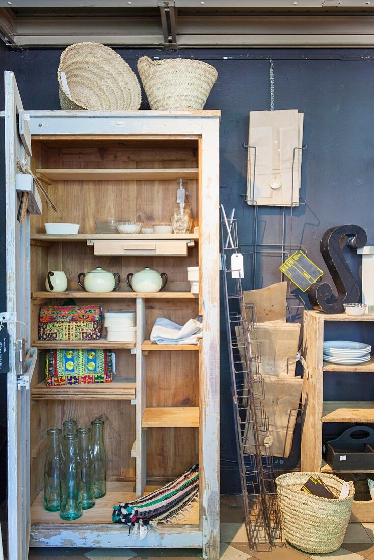 Open cupboard in shop selling vintage items and accessories