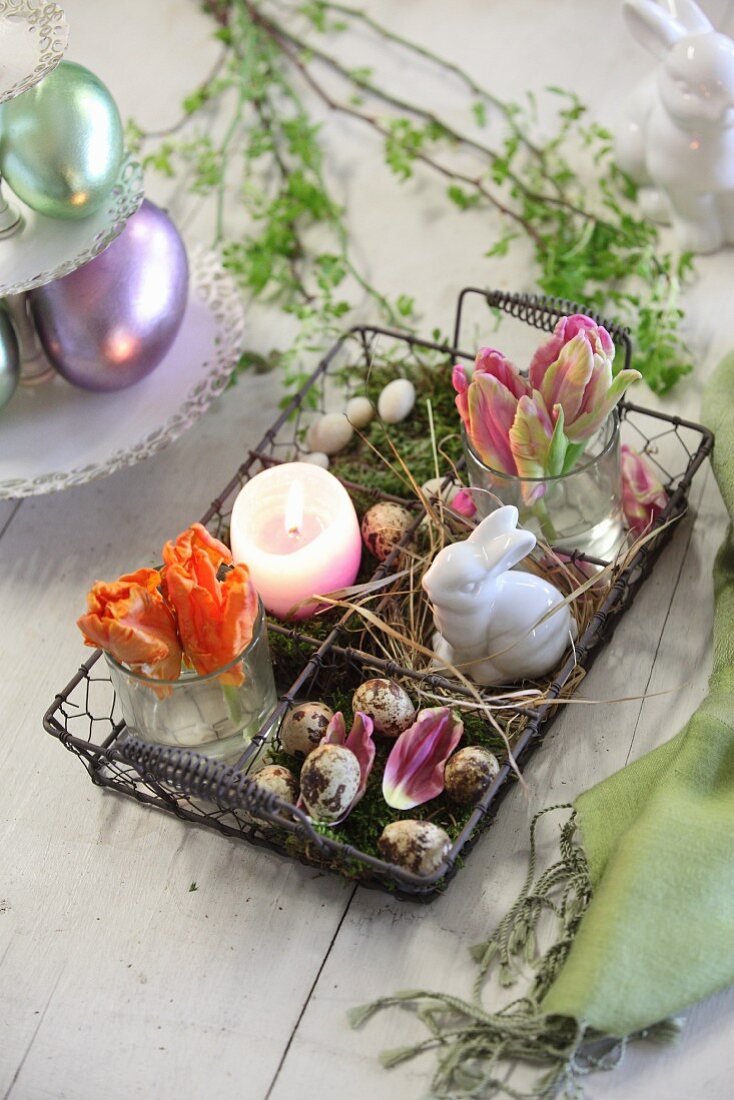 Easter arrangement in decorative wire basket on wooden table
