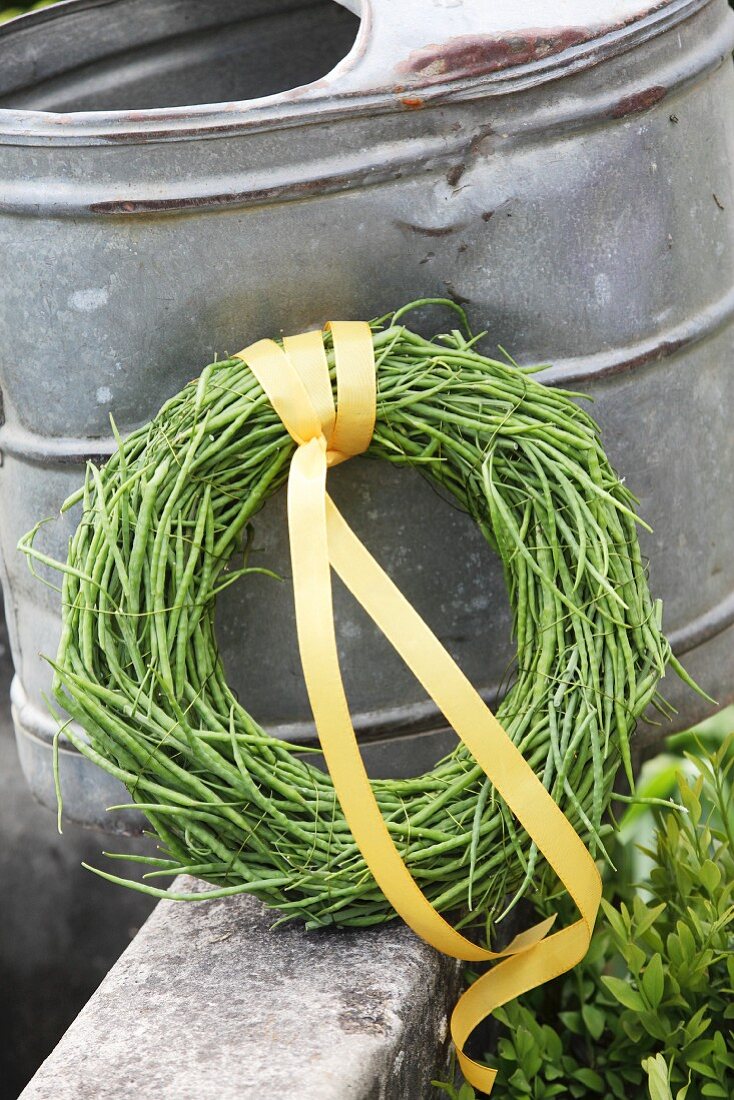 Wreath of rapeseed pods tied with yellow ribbon