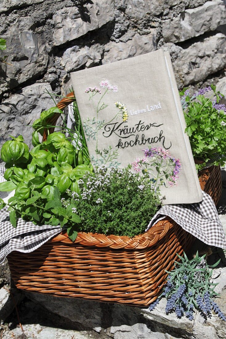 Book cover embroidered with floral motifs and herbs in wicker basket