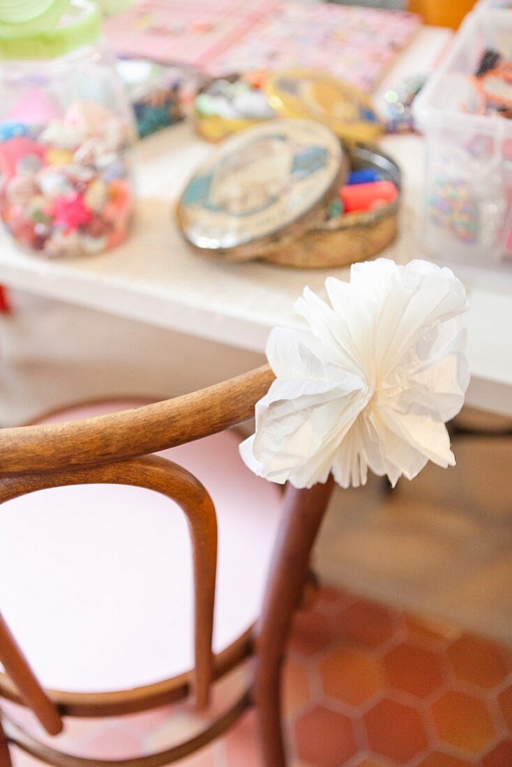 White paper flower on chair backrest