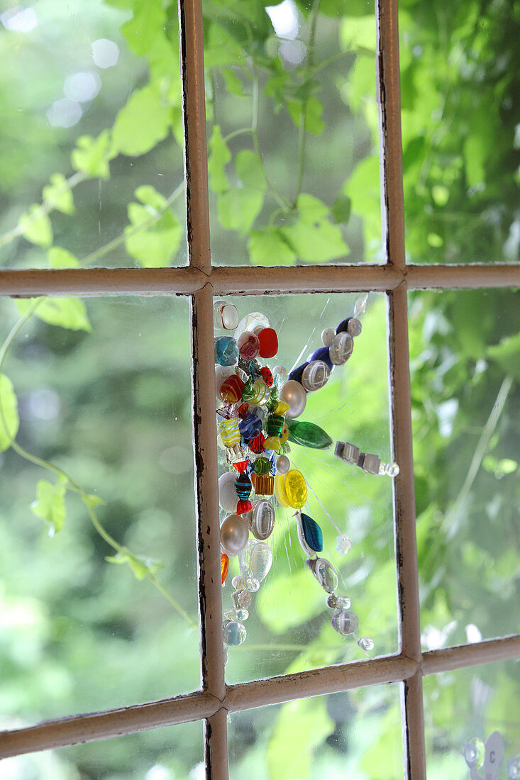 Mit Perlenmosaik dekoriertes Fensterglas