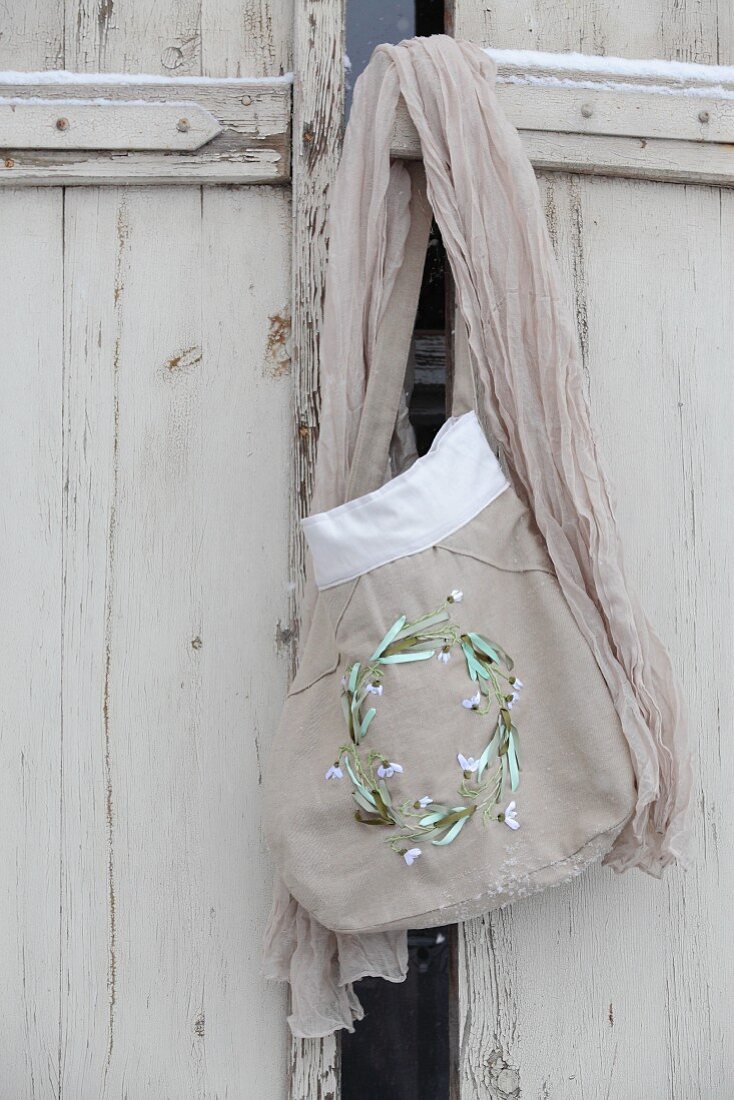 Hand-sewn fabric bag with embroidered snowdrops