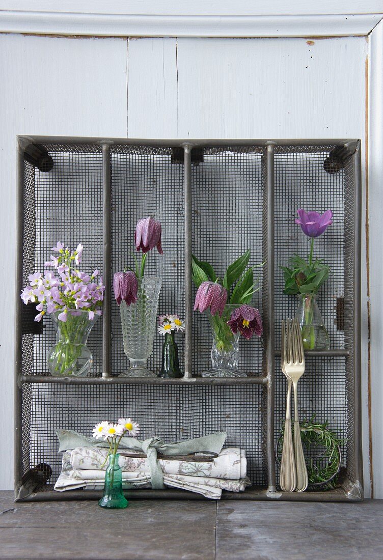 Aufgestellter Metall-Besteckkasten mit verschiedenen Frühlingsblumen dekoriert