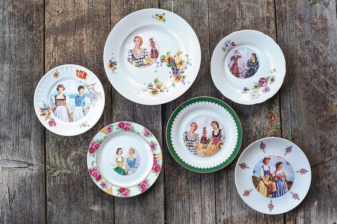 Hand-made decorative wall plates with pictures of women in traditional costume and flowers