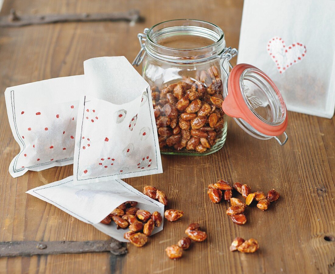 Candies almonds in preserving jar and in hand-made gift bags