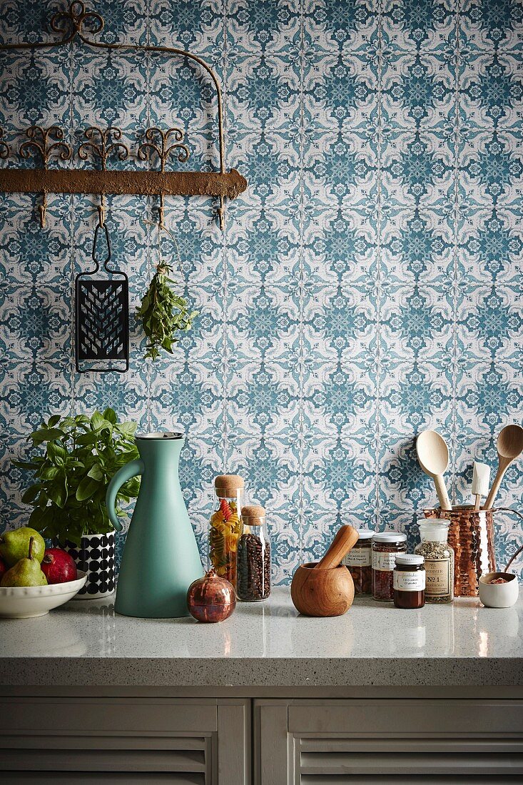 Kitchenette in front of blue and white pattern wallpaper