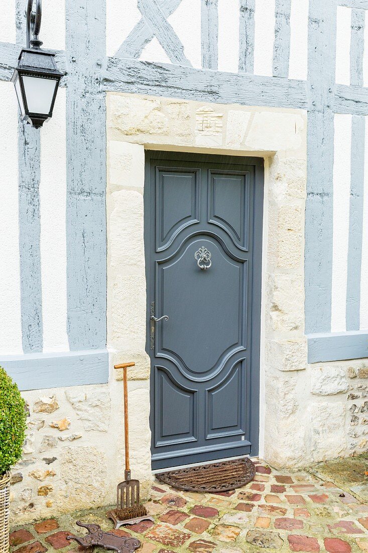 Elegant blue-grey front door of traditional half-timbered house