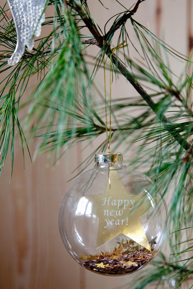 'Happy New Year' written on glass Christmas bauble