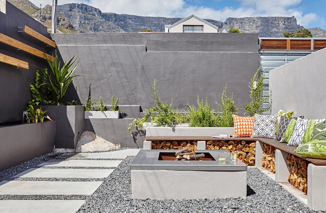 Fireplace and masonry bench in courtyard in shades of grey