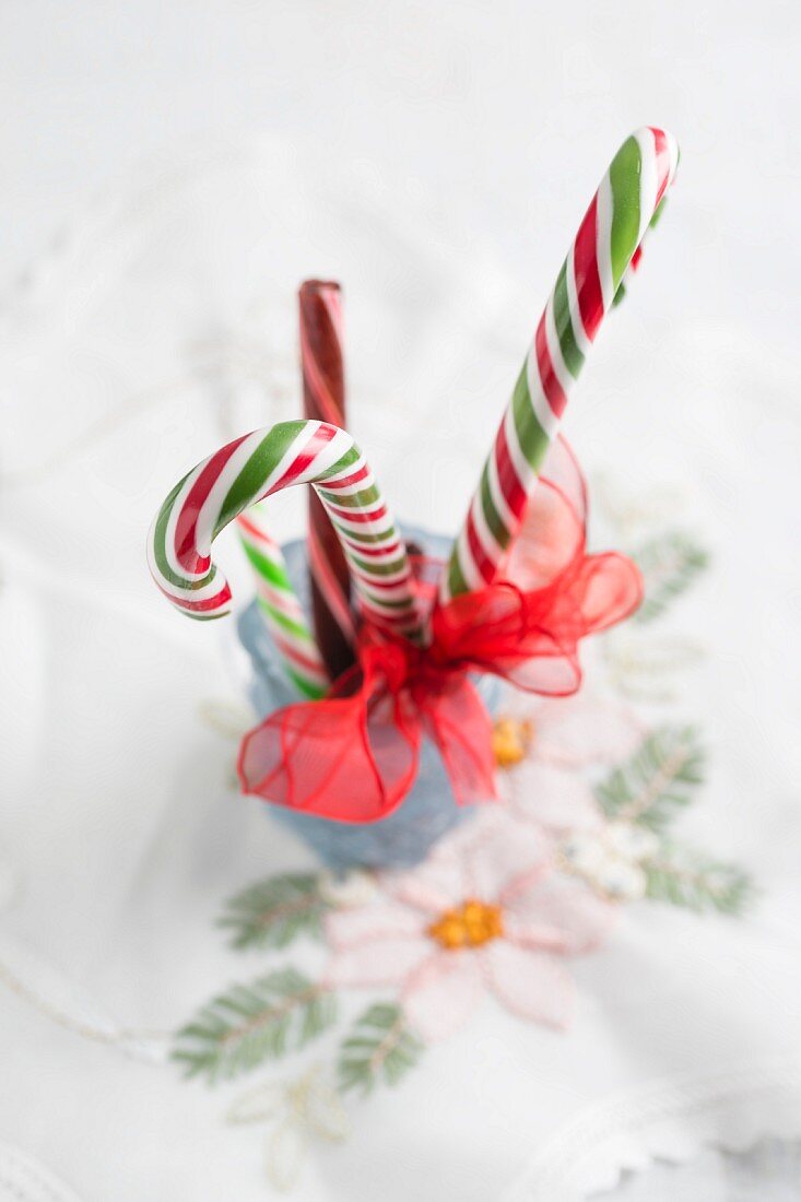 Weihnachtliche Zuckerstangen mit Schleife umwickelt im Glas