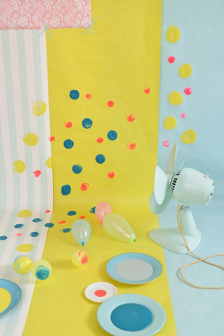 Wallpaper and gift wrap brightened up with colourful spots of paint