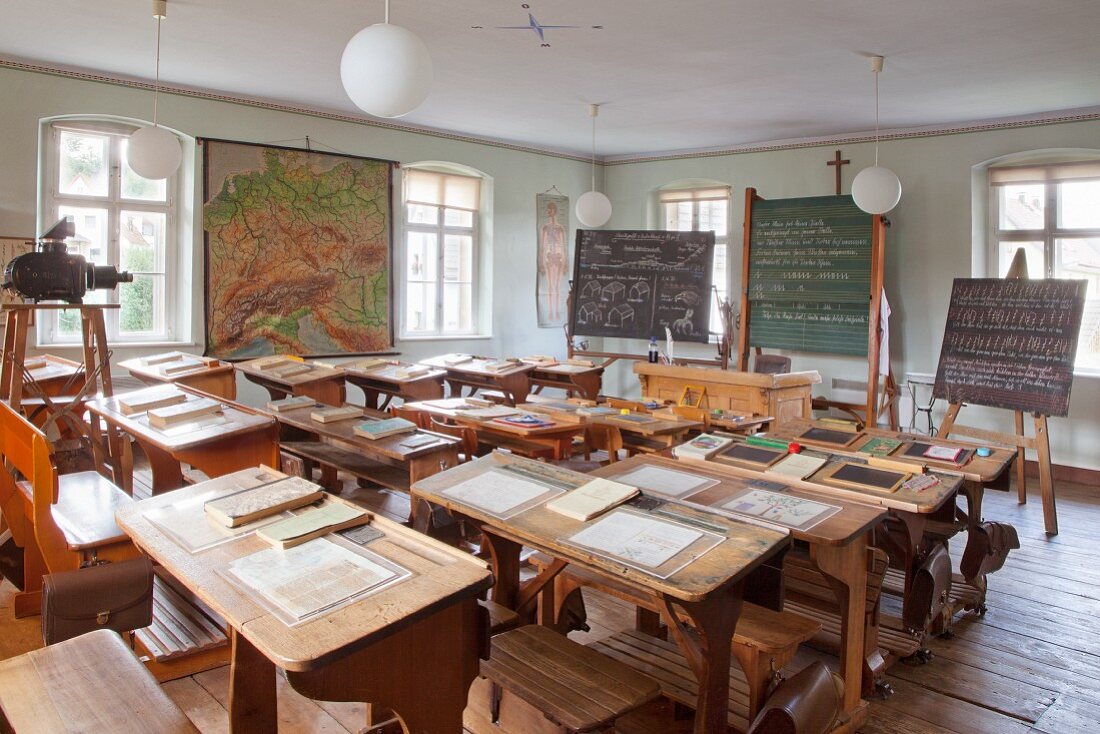Slates on old school desks in vintage schoolroom in village school museum