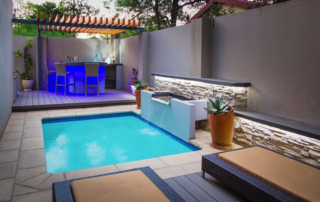 Modern courtyard with pool and illuminated bar