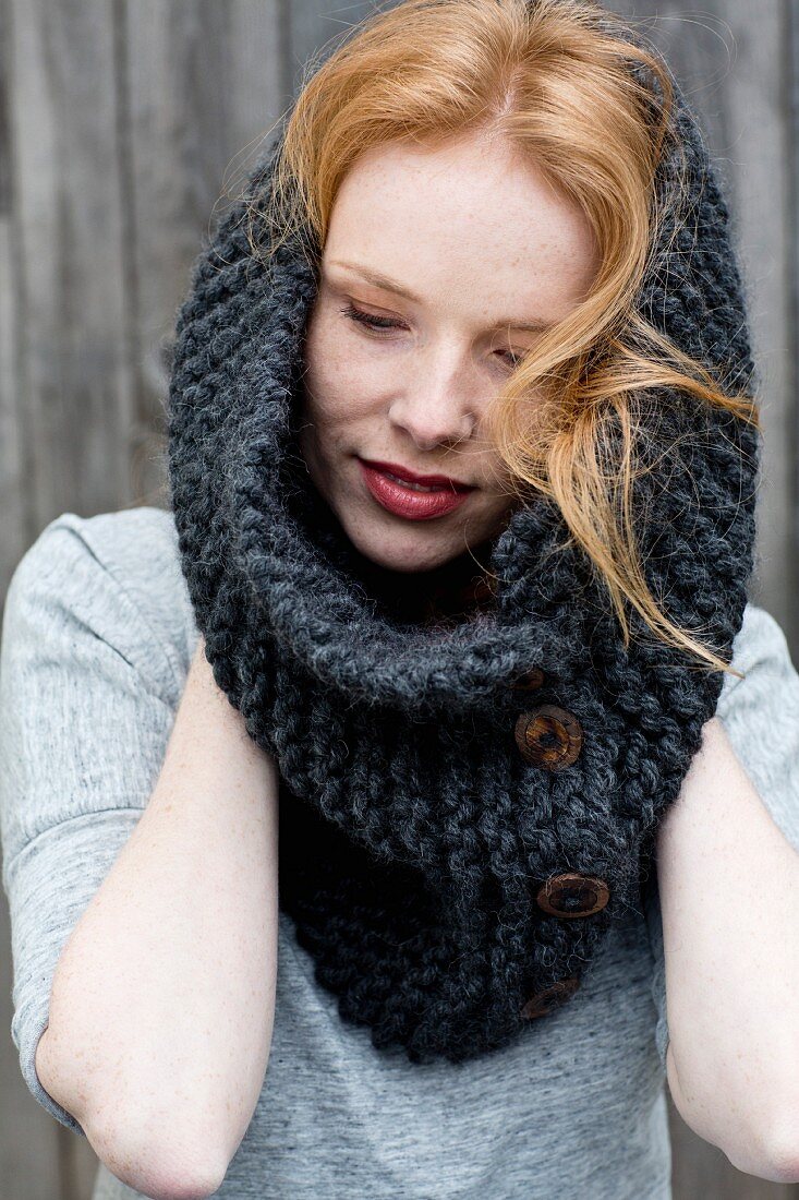 A hand-knitted buttoned loop scarf mado of marino & alpaca yarn