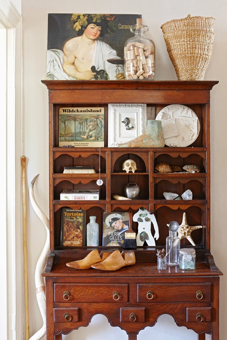 Vintage collectibles in compartments of old wooden writing desk