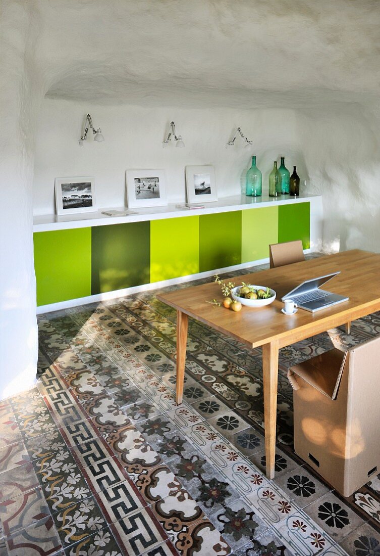Various floor tiles in Mediterranean interior with fitted sideboard, cardboard chairs and retro ambiance
