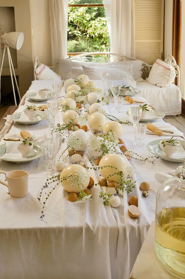 Easter table set with ostrich eggs and hens' eggs