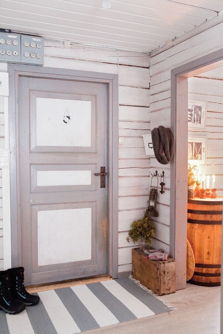 Grey and white front door in rustic Swedish house
