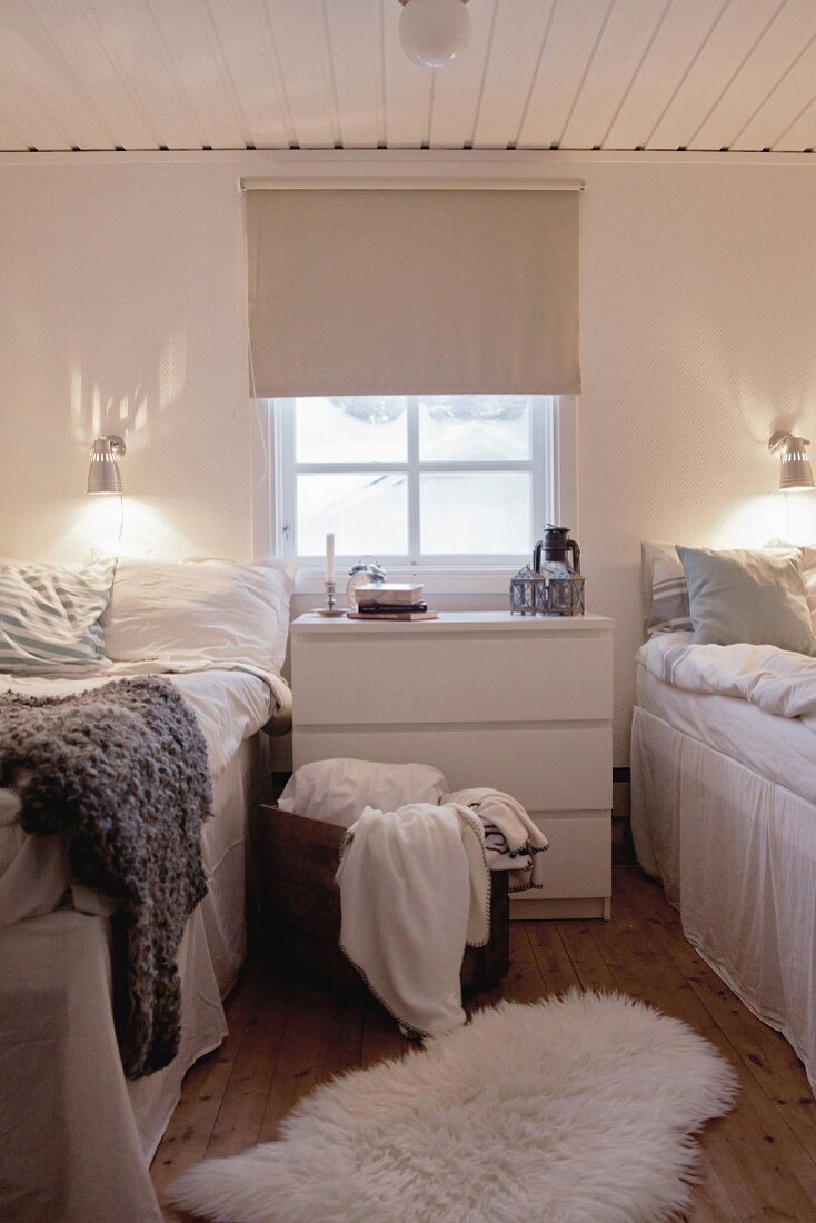 Lattice window and chest of drawers between twin beds