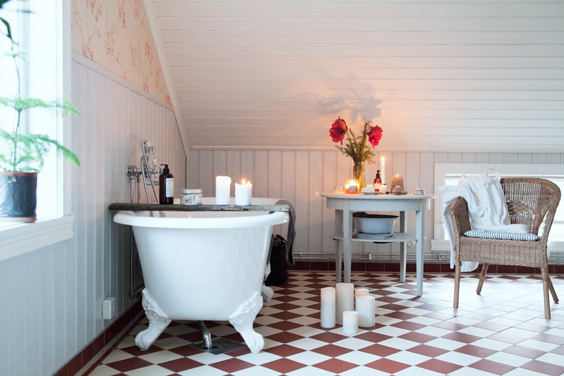 Candlelit, attic bathroom with chequered floor