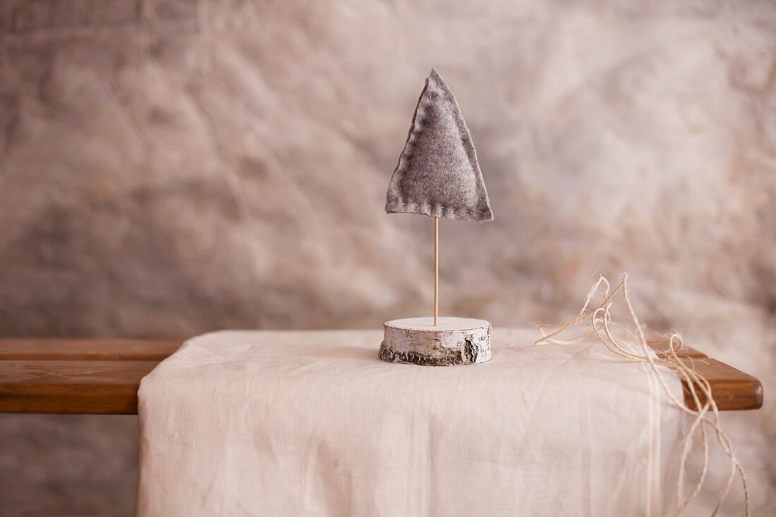 Small felt Christmas tree on stand made from slices of birch