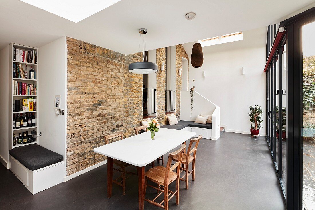 Brick wall and modern benches in dining room