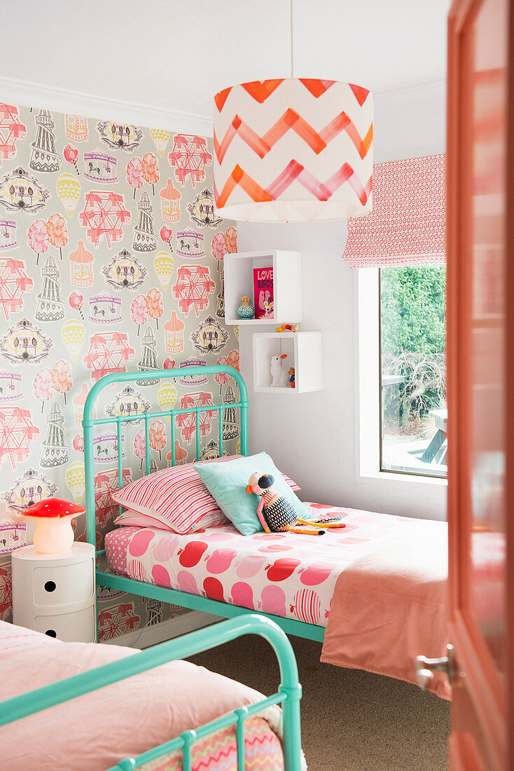 Glance into the nostalgic children's room with two metal beds