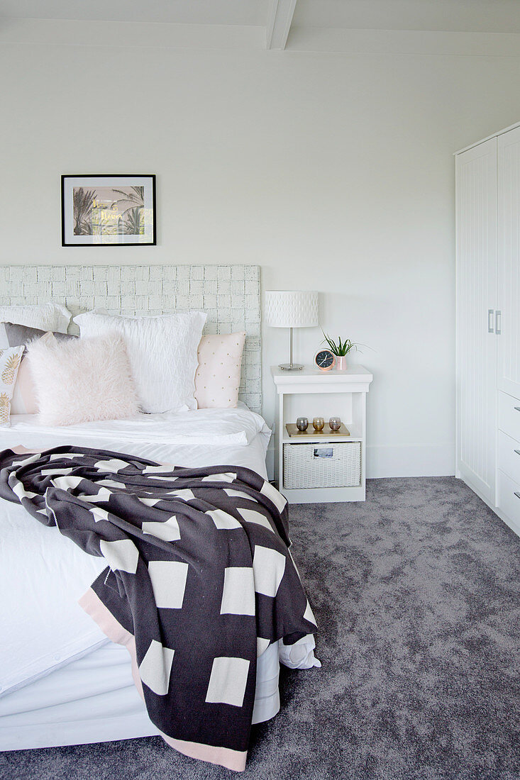 Bright bedroom with gray carpeting