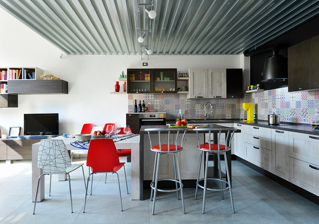 Designer chairs in kitchen and dining area of industrial loft apartment