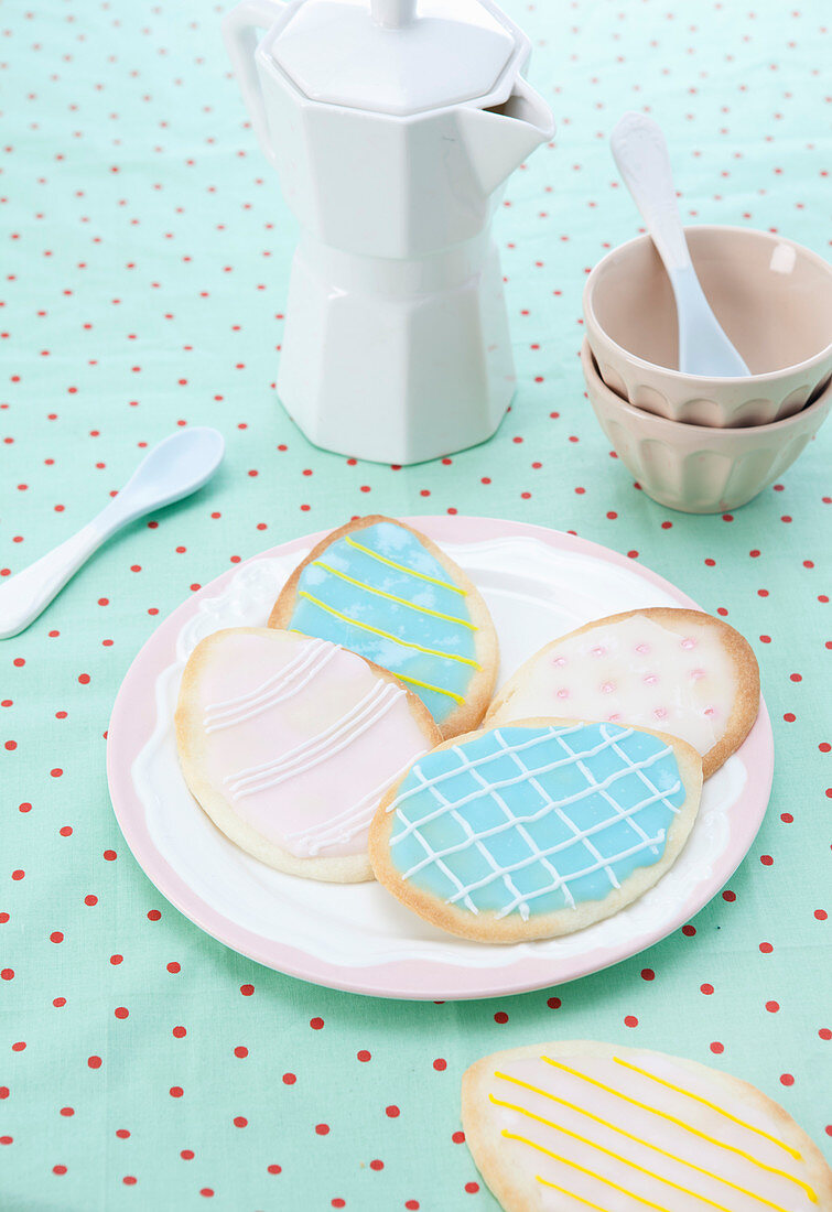 Iced Easter-egg biscuits on plate