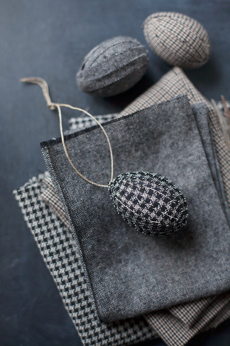 Easter eggs wrapped in checked fabric and fabric remnants
