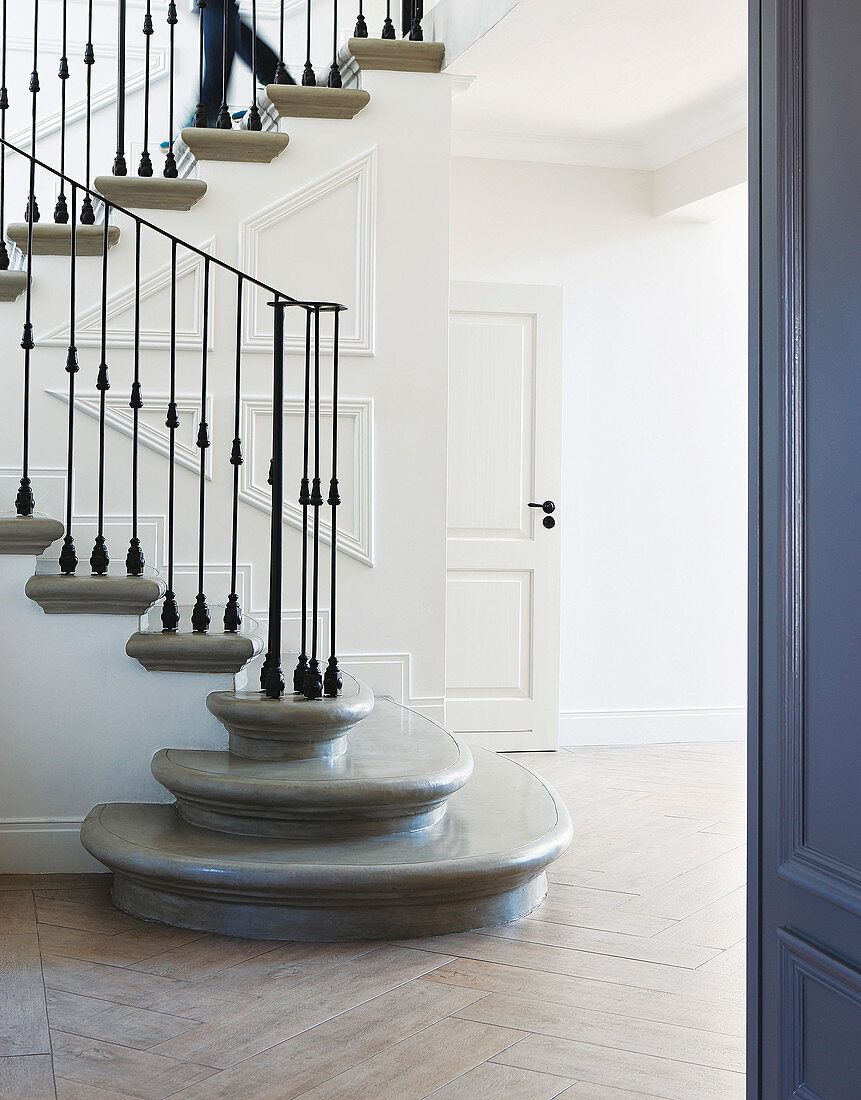 Classic foyer with elegant staircase and panelled walls