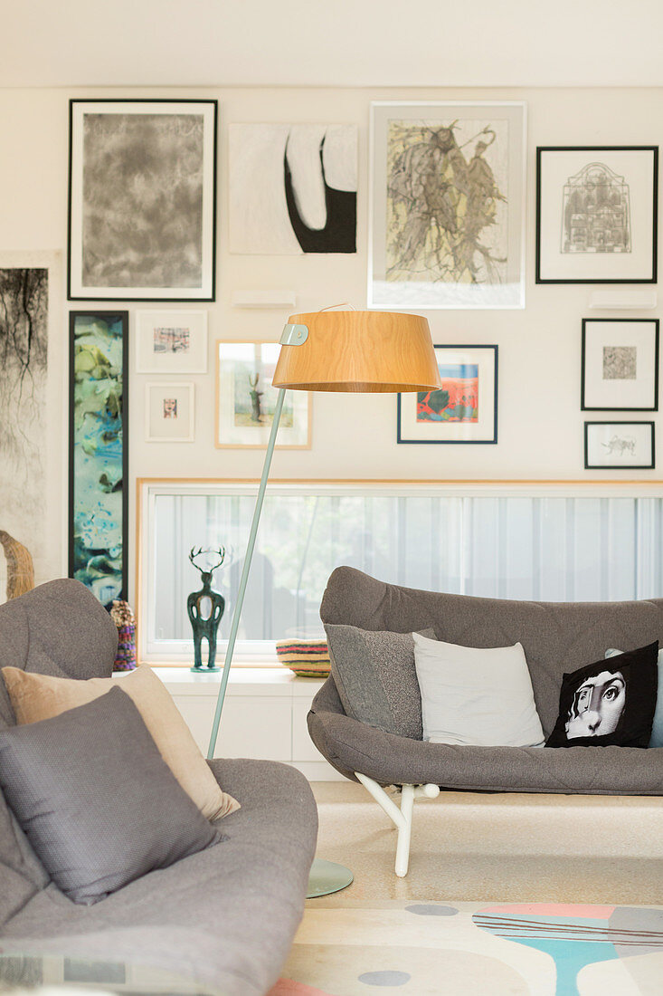 Scandinavian style sofas in front of a picture wall with a horizontal window