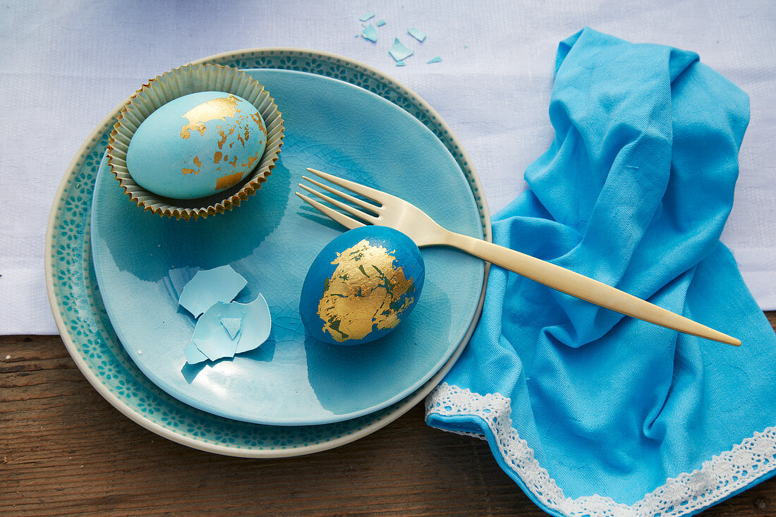 Blue Easter eggs decorated with gold leaf