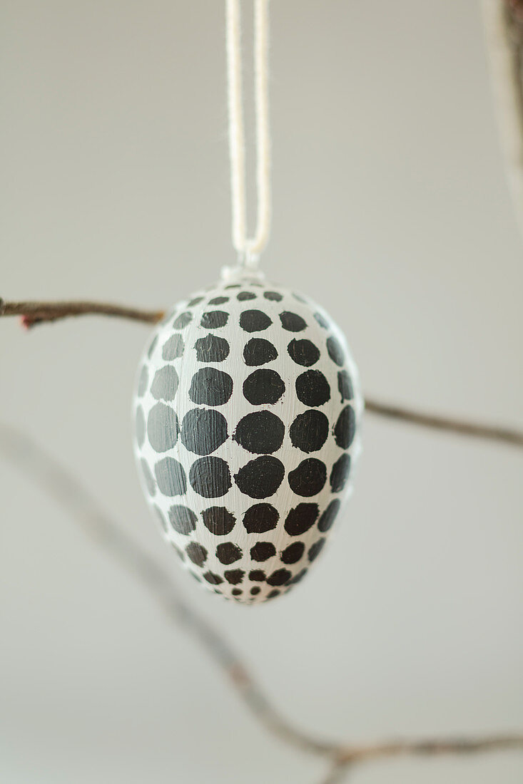 Easter egg painted with black polka dots