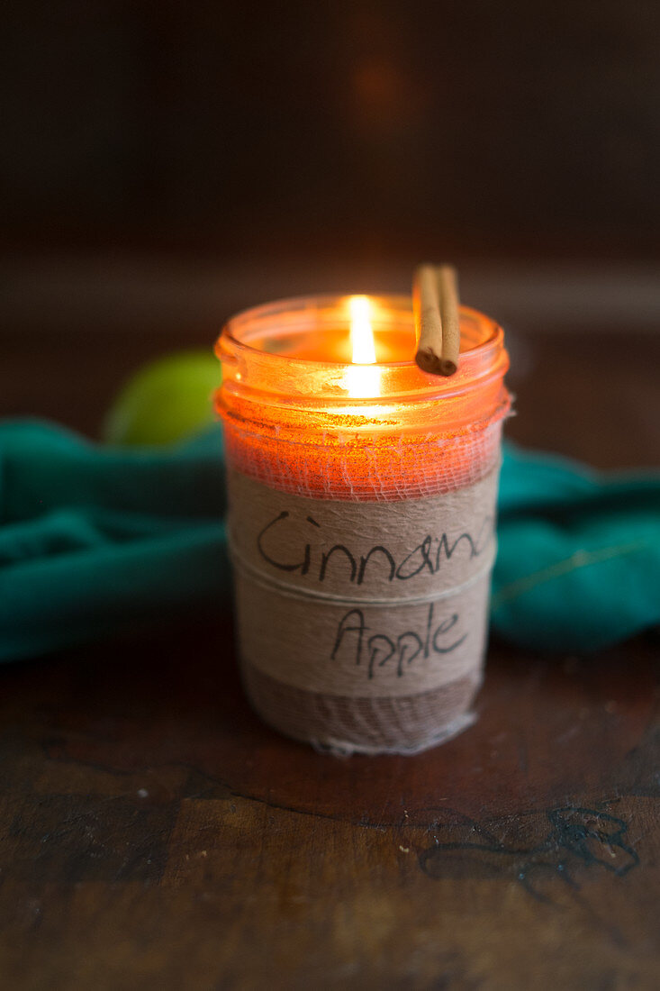 Cinnamon and apple scented candle in jar