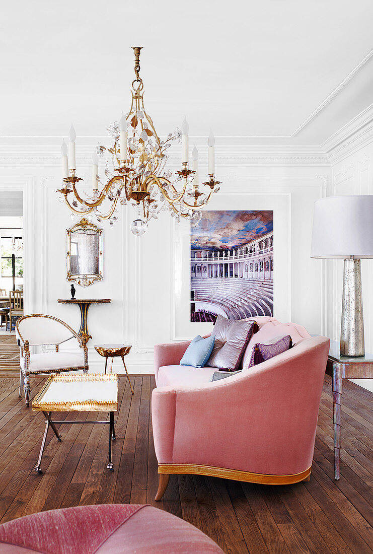 Elegant upholstered sofa and coffee table under a chandelier