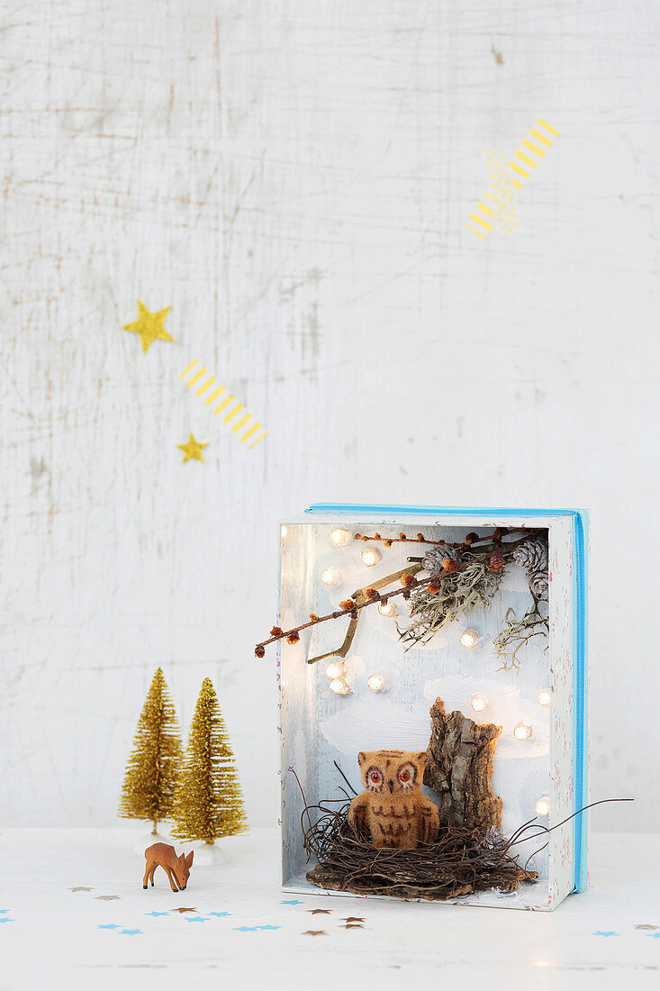 Hand-crafted, miniature, Christmas diorama with fairy lights