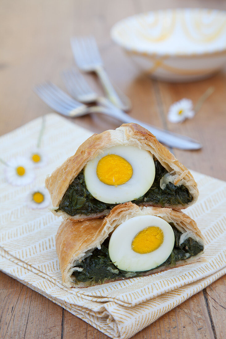 Two pieces of Easter strudel filled with spinach and egg
