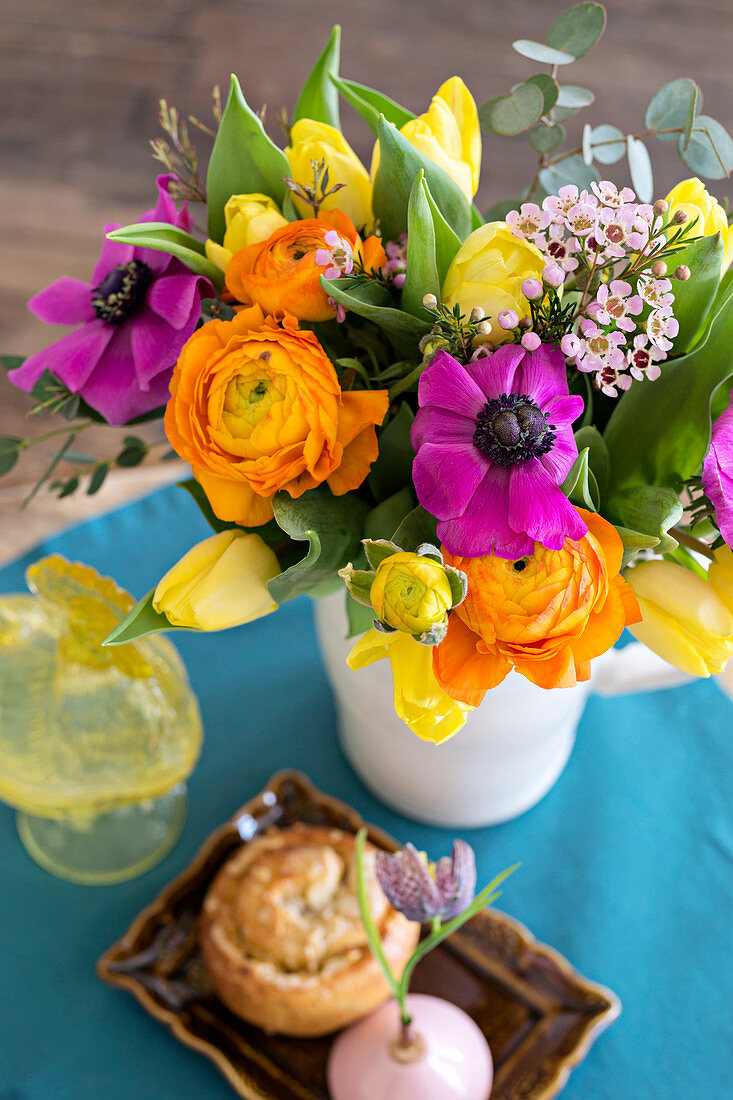 Spring bouquet of tulips, anemones, ranunculus and waxflowers