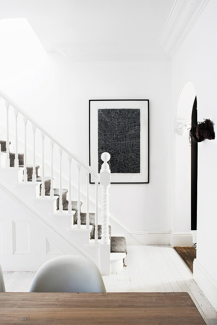 View of white painted wooden staircase with carpet